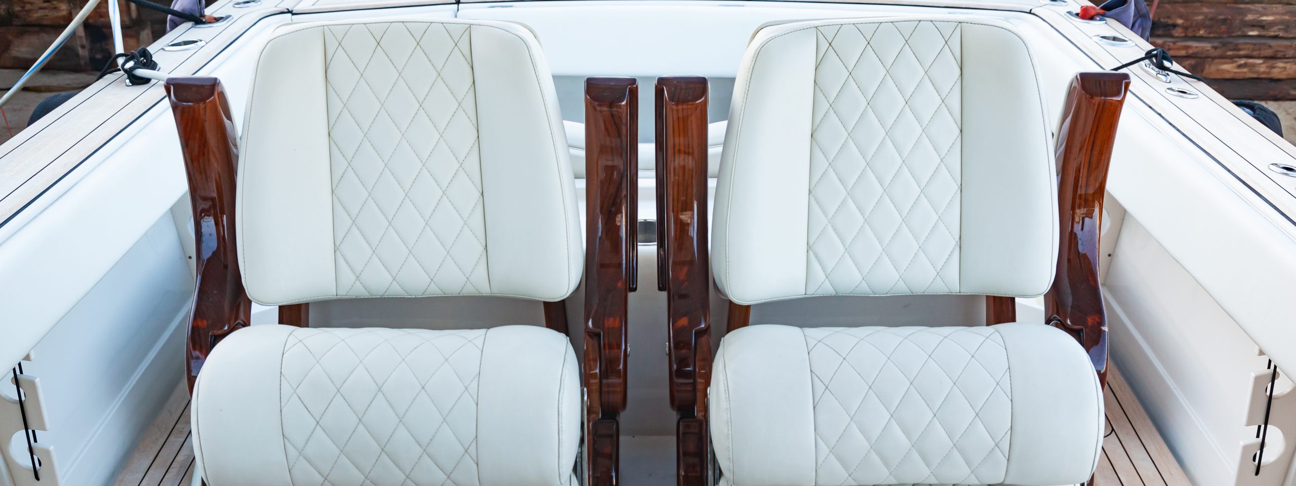Two white leather armchairs on a luxury motor boat, close-up.